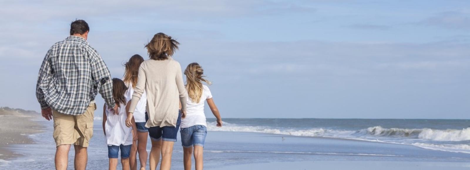 Family on a beach, cheap caravan holidays in wales